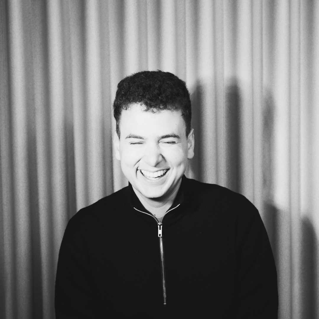 Porträt von Alex Gill vor einem Vorhang
